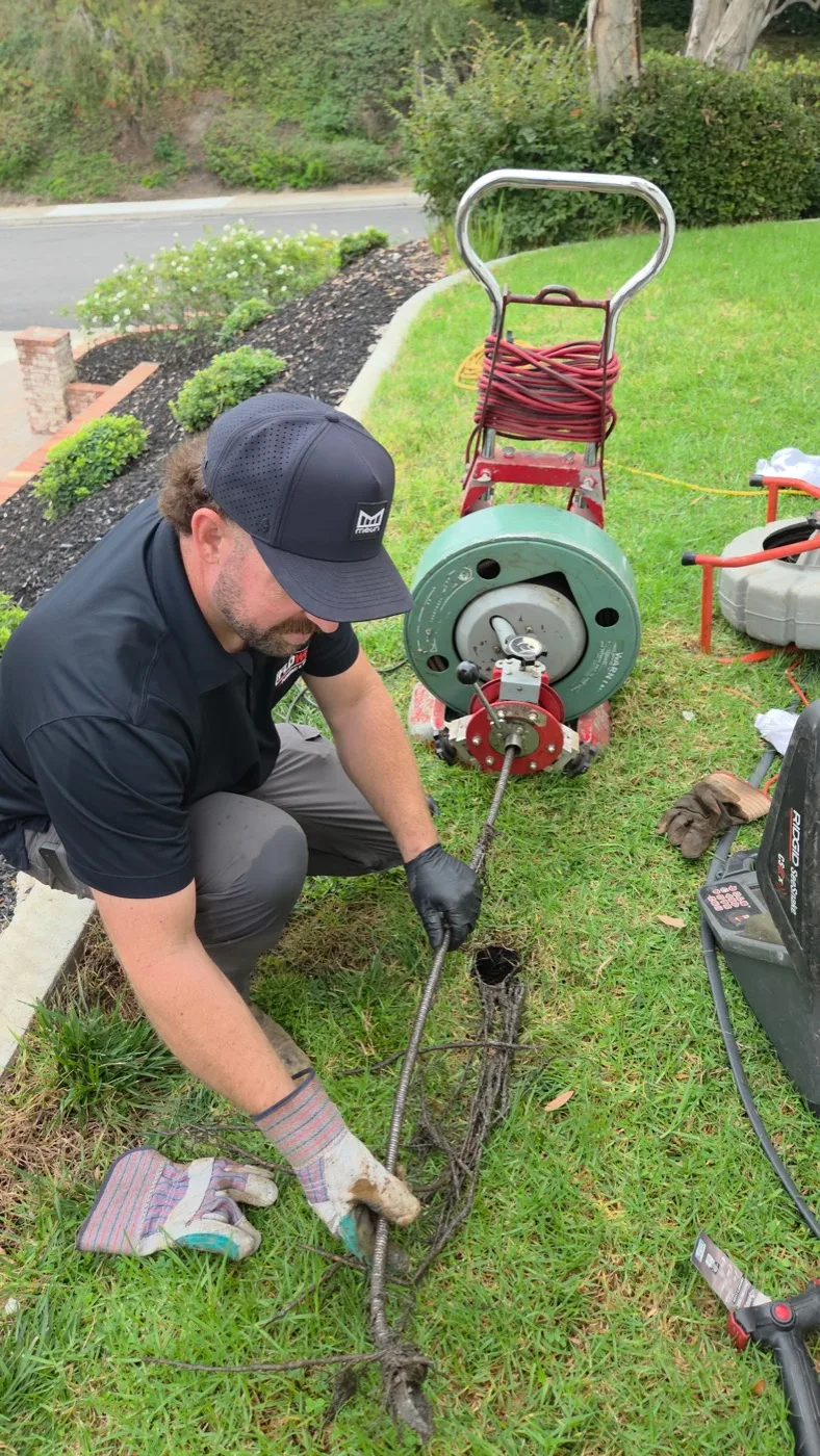 Floworx plumber clearing a sewer line outdoors